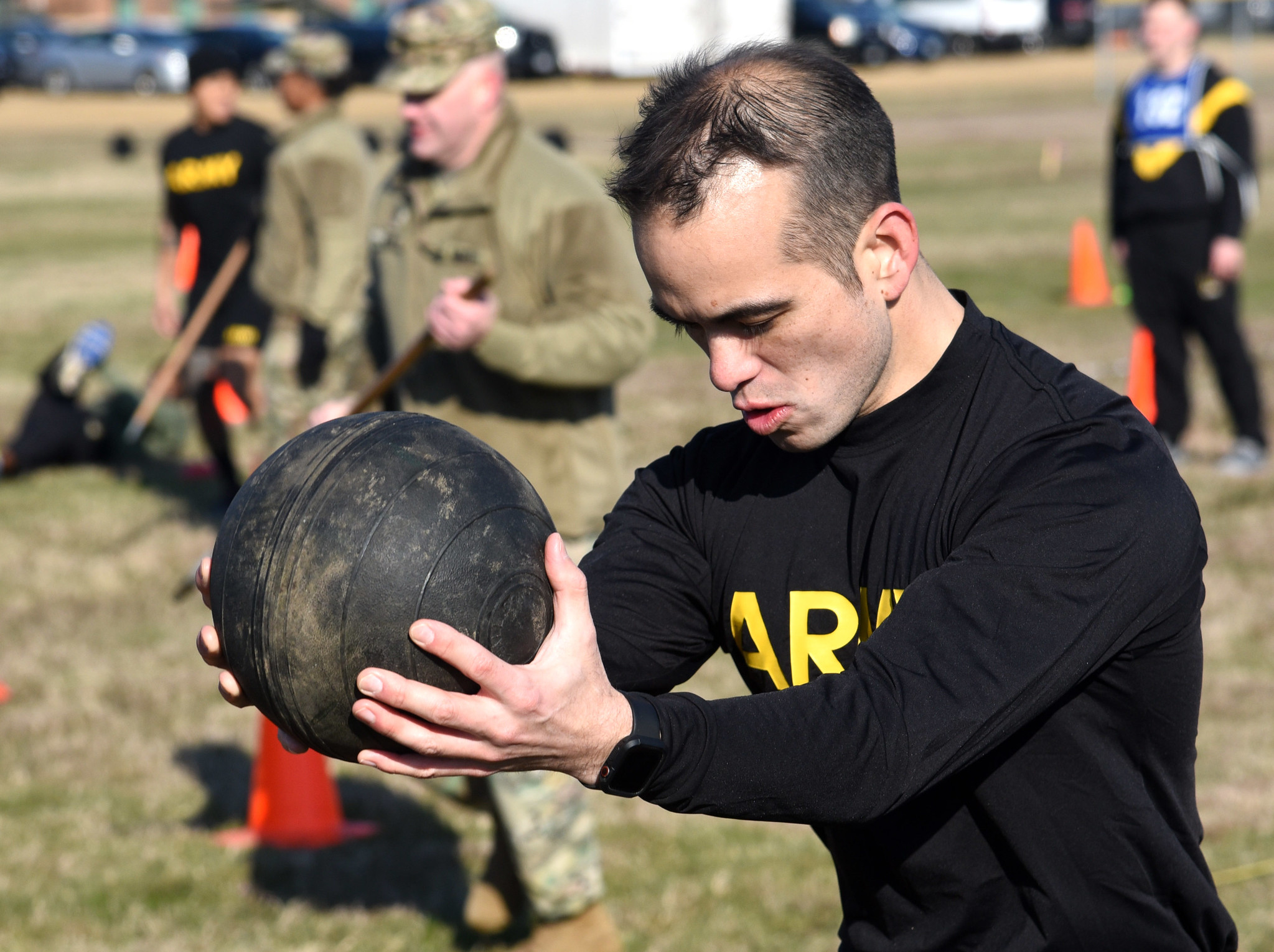 Army man training with medicine ball in his hands