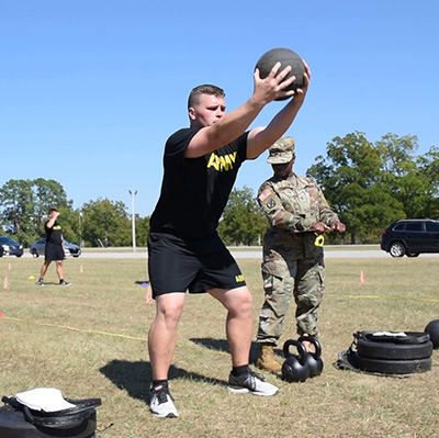 Army Man Throwing Medicine Ball To Train Arms